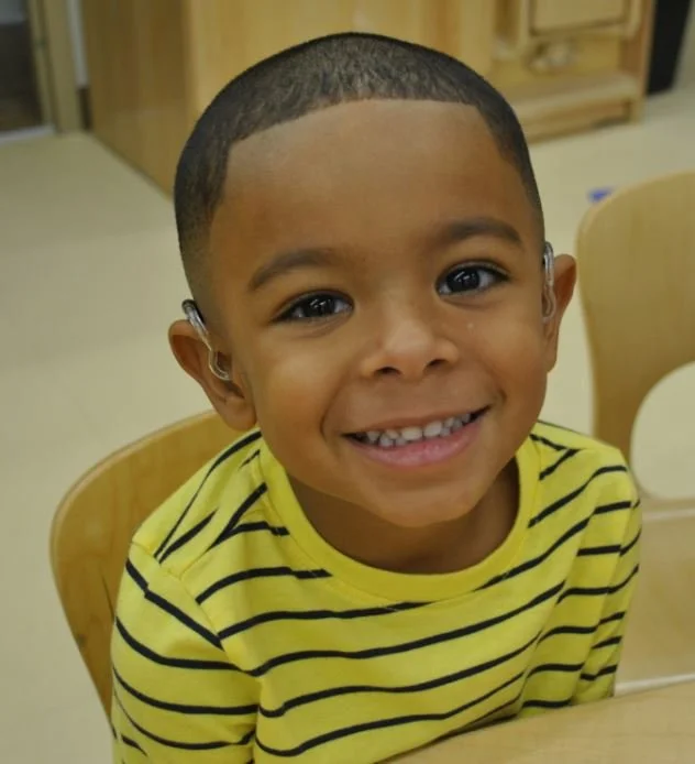 blk boy with hearing aid.jpeg