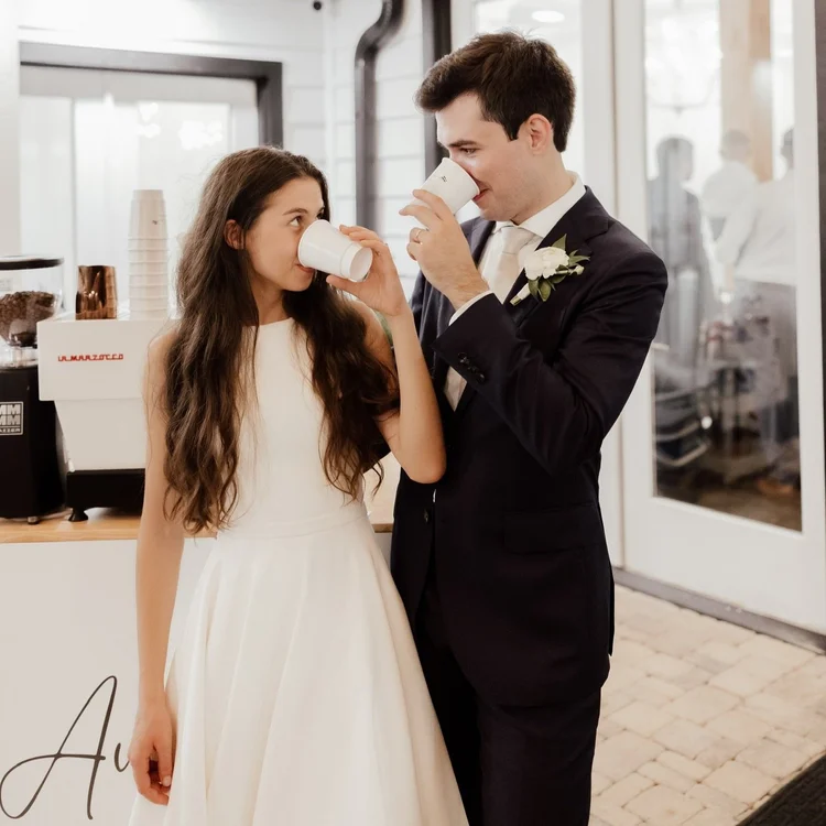 Couple drinking coffee from the Aviator espresso bar at their wedding