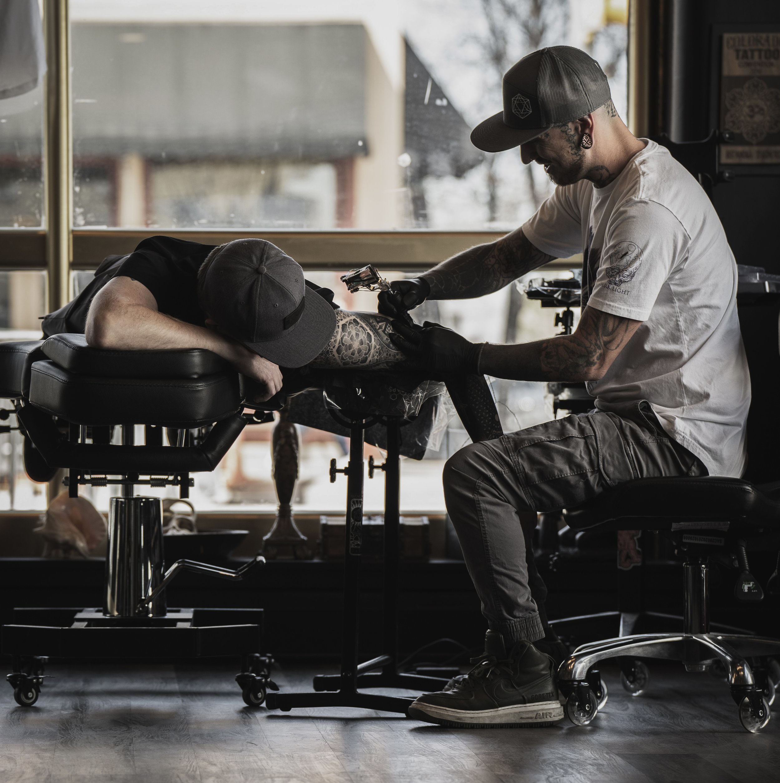 Zach Atlan, owner of Dark Light Tattoo, finishes a session with a client on Apr. 16, 2022, in Fort Collins, Colo. Atlan has been tattooing for more than nine years, boasting a unique realistic style. Photo by Merit Davey.