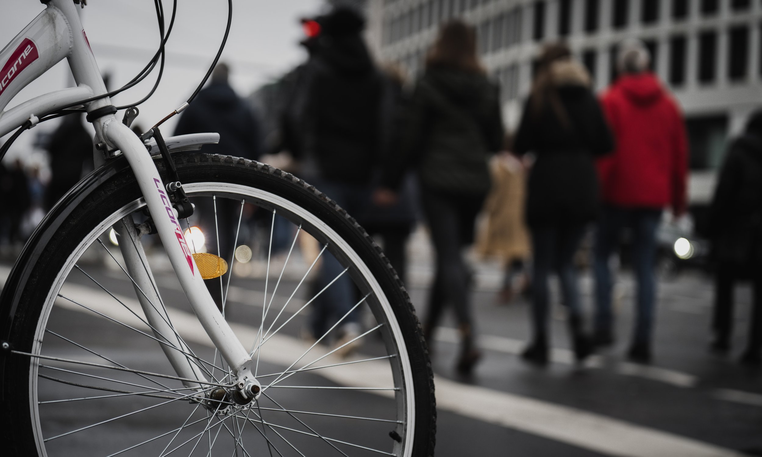 A cyclist yields to crossing pedestrians in Berlin, Germany, on Jan. 2, 2022. © Merit Davey 2022.