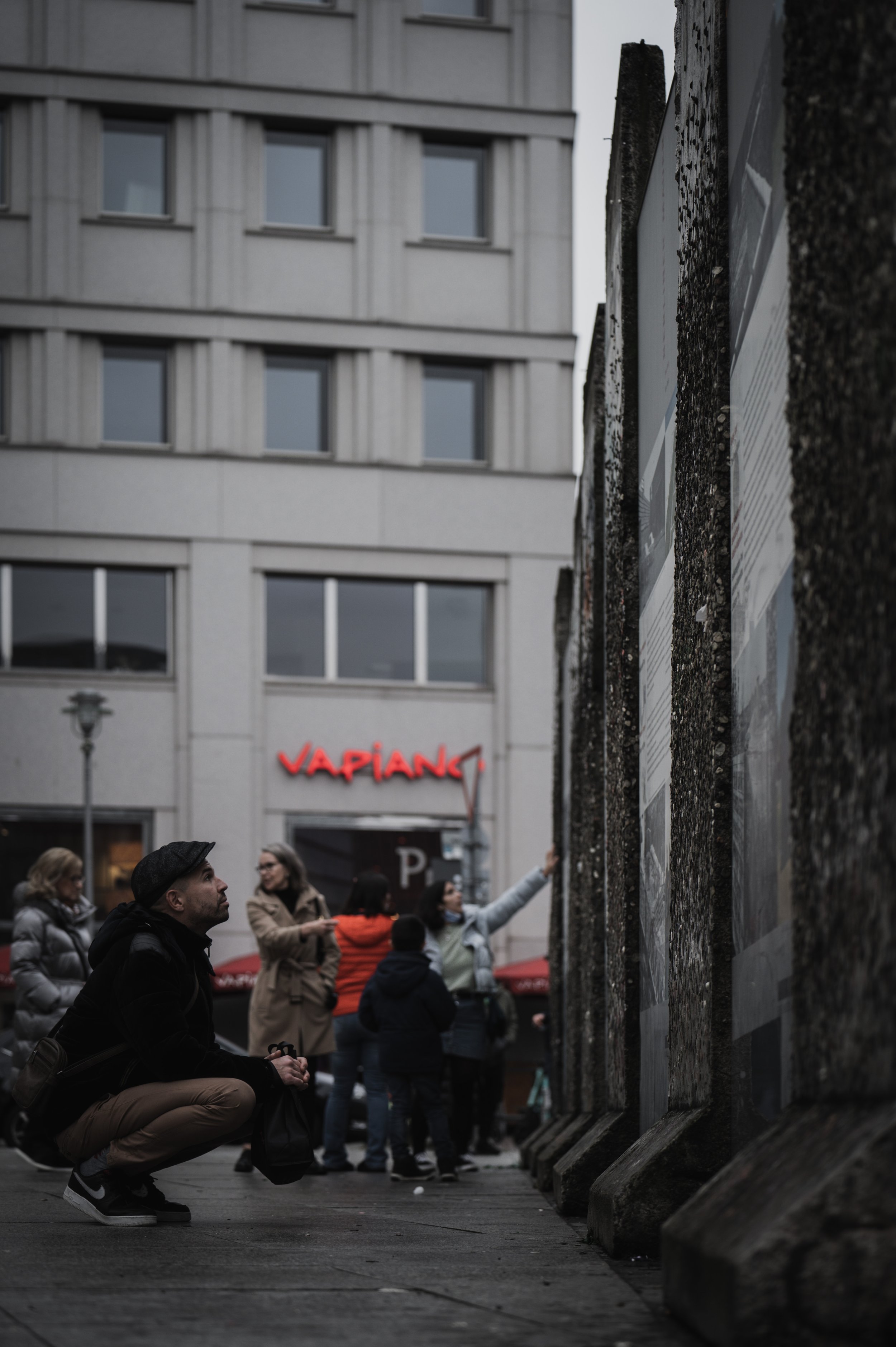 A man examines a Berlin Wall remnant in Berlin, Germany, on Jan. 2, 2022. Potsdamer Platz hosts one of the last standing sections of the original Berlin Wall. The relic, now covered in layers of discarded chewing gum, remains a distant reminder of th