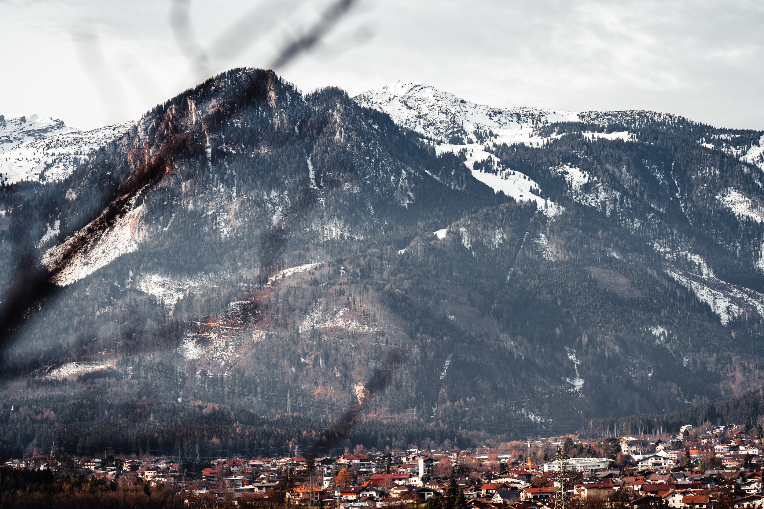 The view overlooking Rattenberg, Austria on Dec. 19, 2021. Most Austrian towns sit peacefully in the bowls of intimidating mountain ranges, inspiring awe and appreciation for nature's rugged beauty. © Merit Davey 2021.