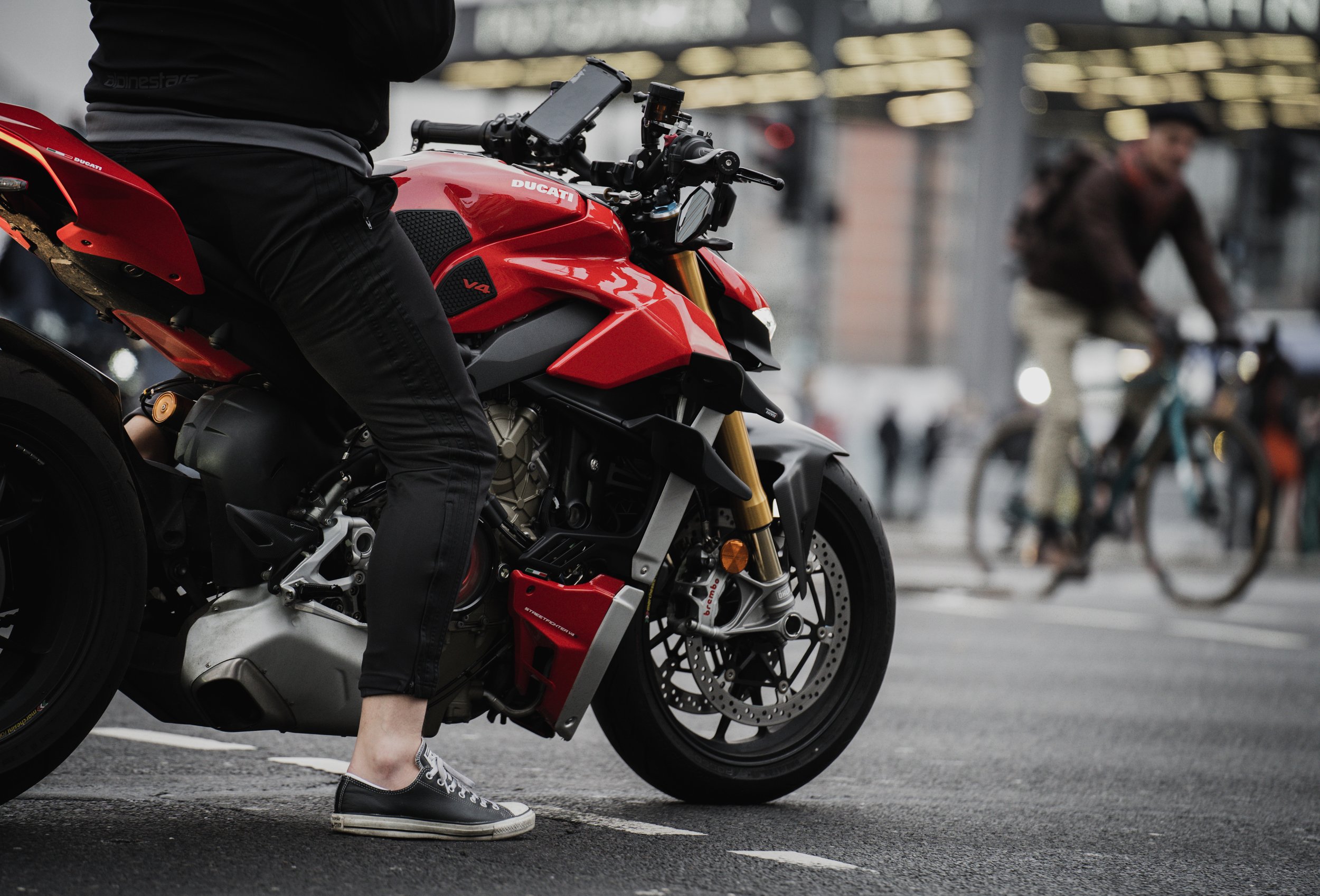 A man waits at a stoplight in Berlin, Germany, on Dec. 30, 2021. In a city dominated by dark gray overtones, this dark red Ducati proudly stood out. © Merit Davey 2021.