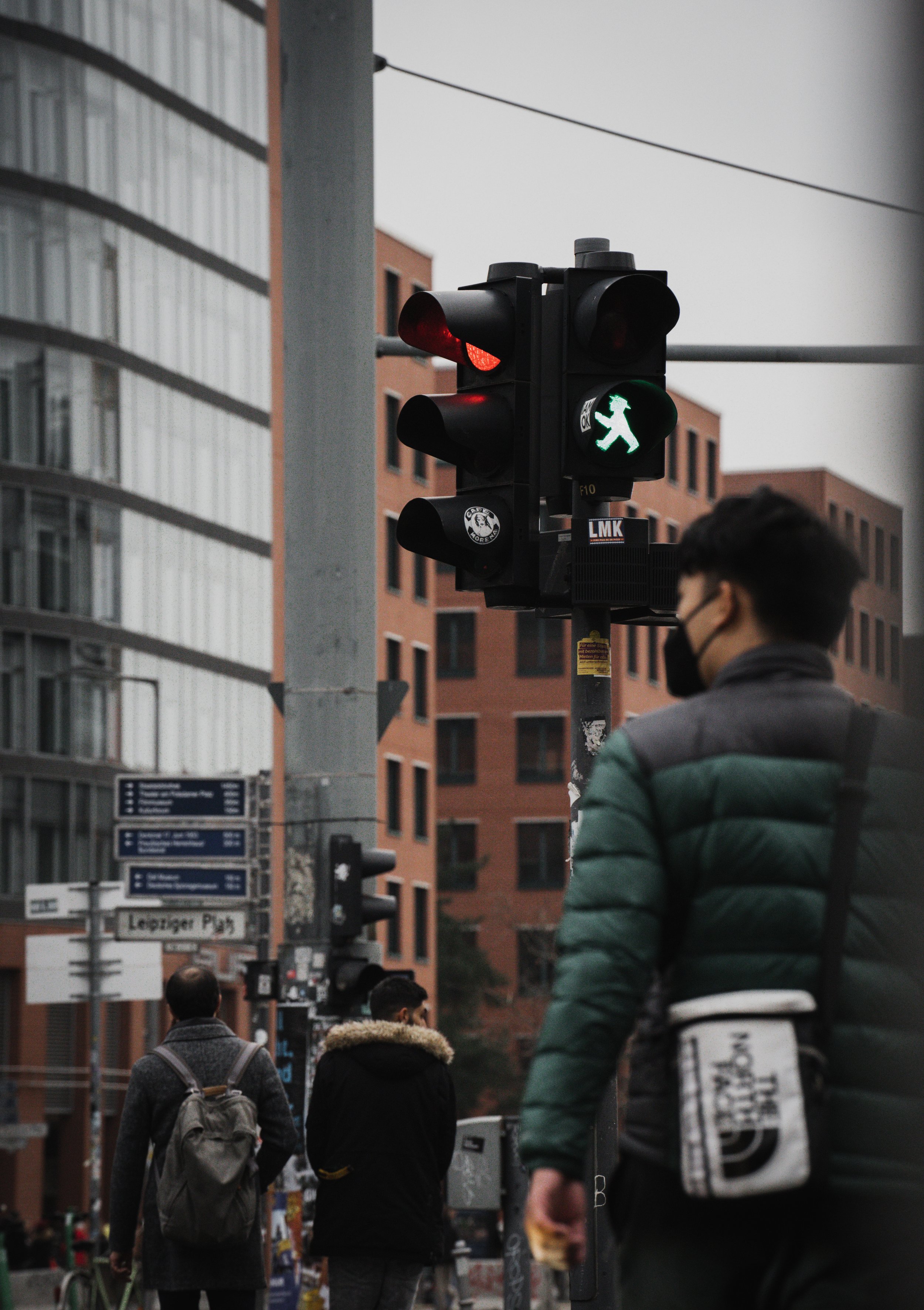A man crosses the street in Berlin, Germany, on Dec. 30, 2021. The infamous Ampelmann crossing signal is a timeless Berlin icon. © Merit Davey 2021.
