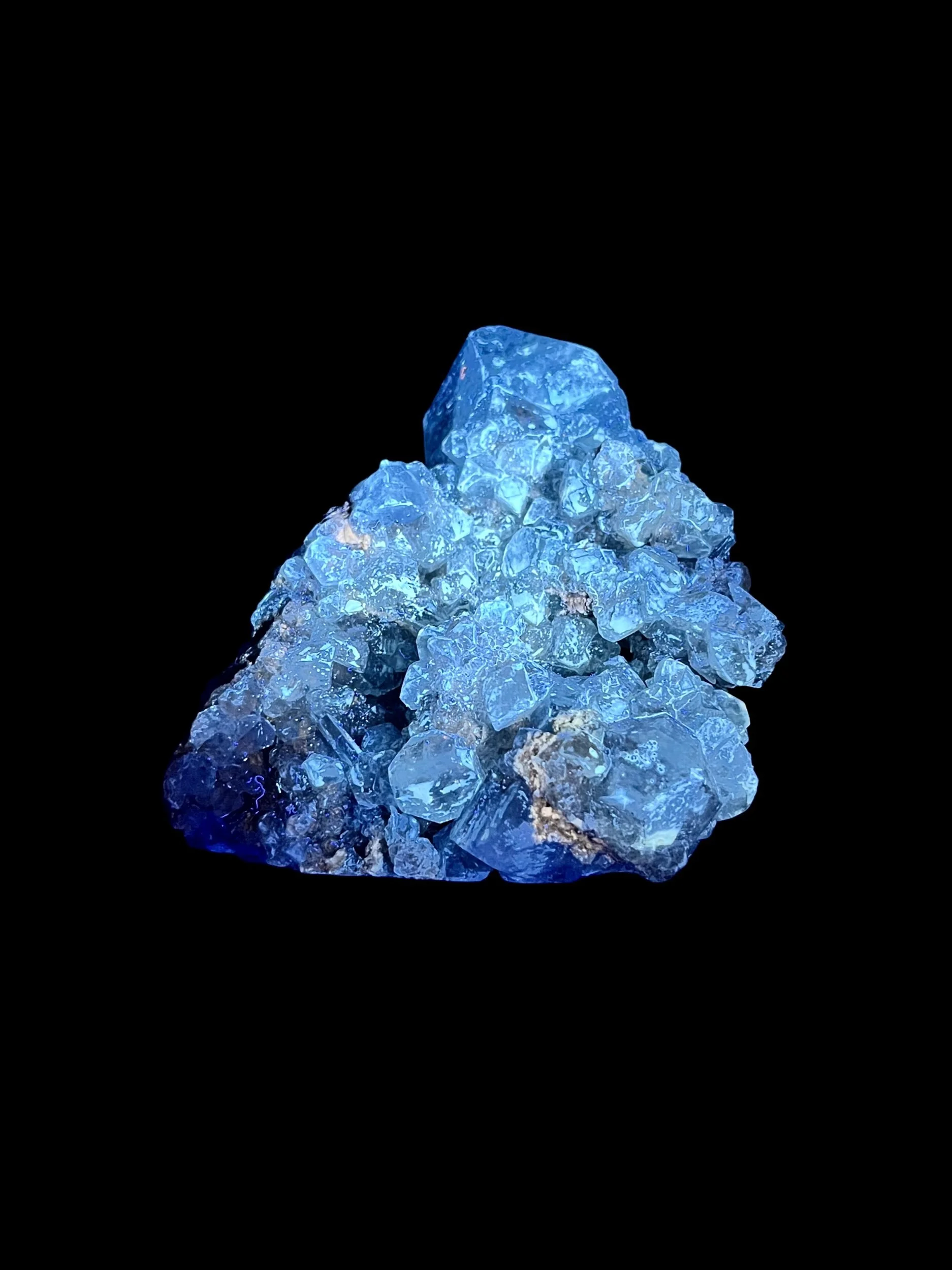 elestite cluster under UV light showing yellow fluorescent calcite