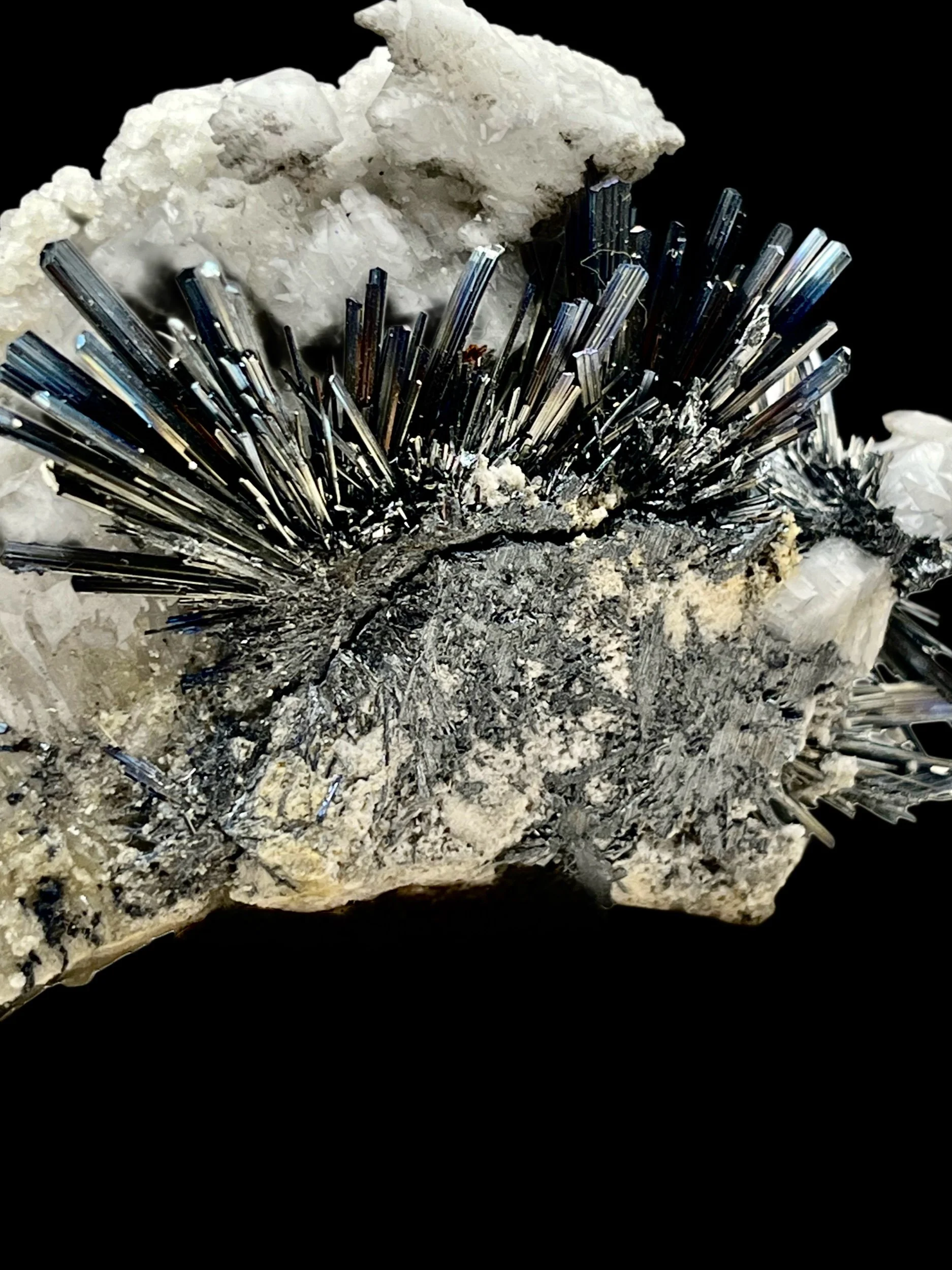 iridescent stibnite crystal spray on white calcite Xikuangshan style specimen