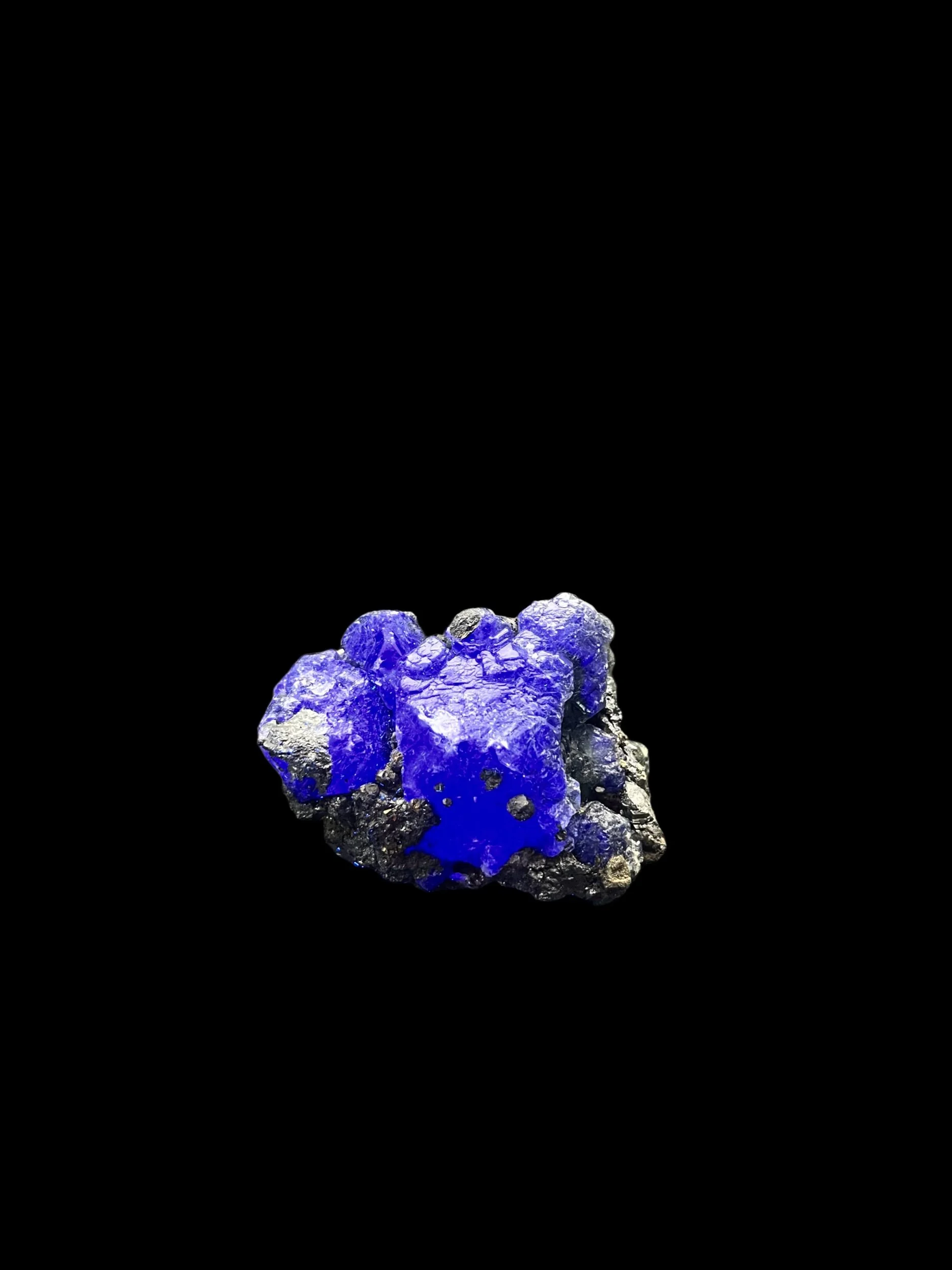 UV reactive Fluorite with Galena and Boulangerite Atacocha Peru glowing blue under ultraviolet light