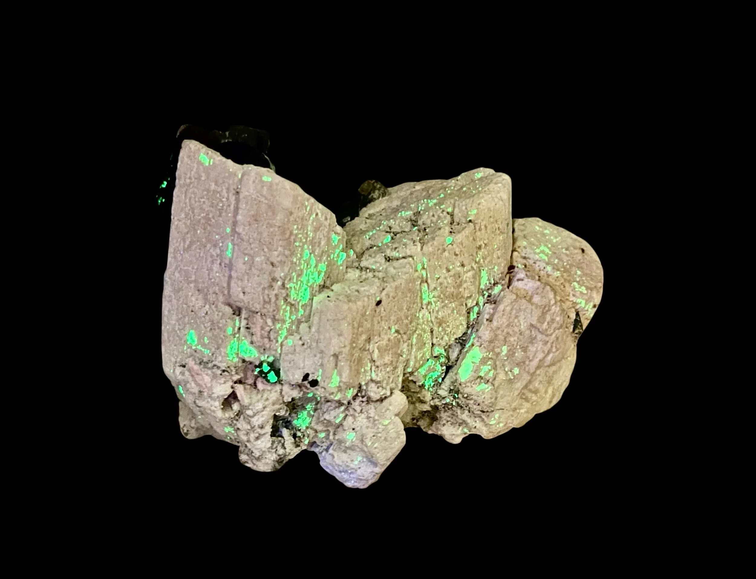 UV fluorescent hyalite opal on black tourmaline and feldspar from Namibia