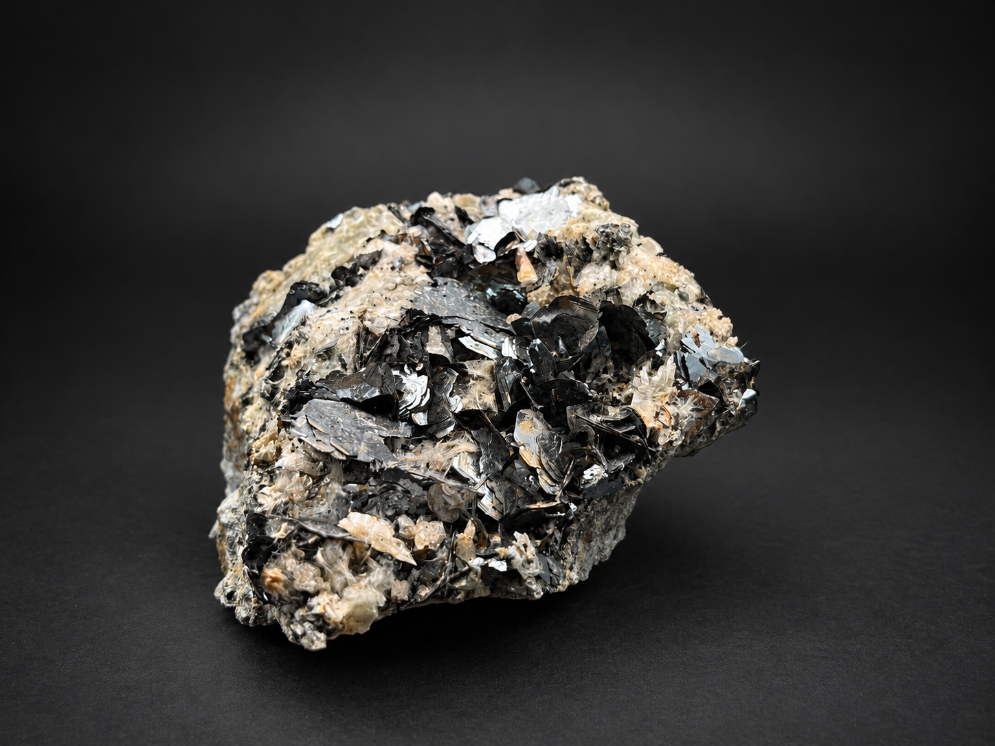large mirrorlike hematite plates from Nador, Morocco, displaying brilliant silver reflections, dark gunmetal blades, and intricate layered crystal growth.