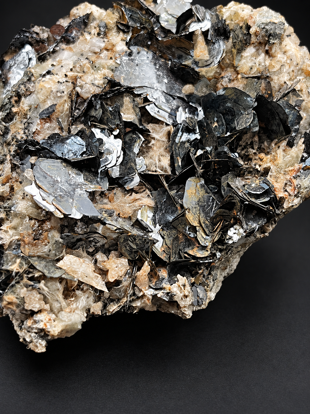 Moroccan specularite hematite with layered mirrorlike black crystals, broad metallic plates, and delicate blade formations.