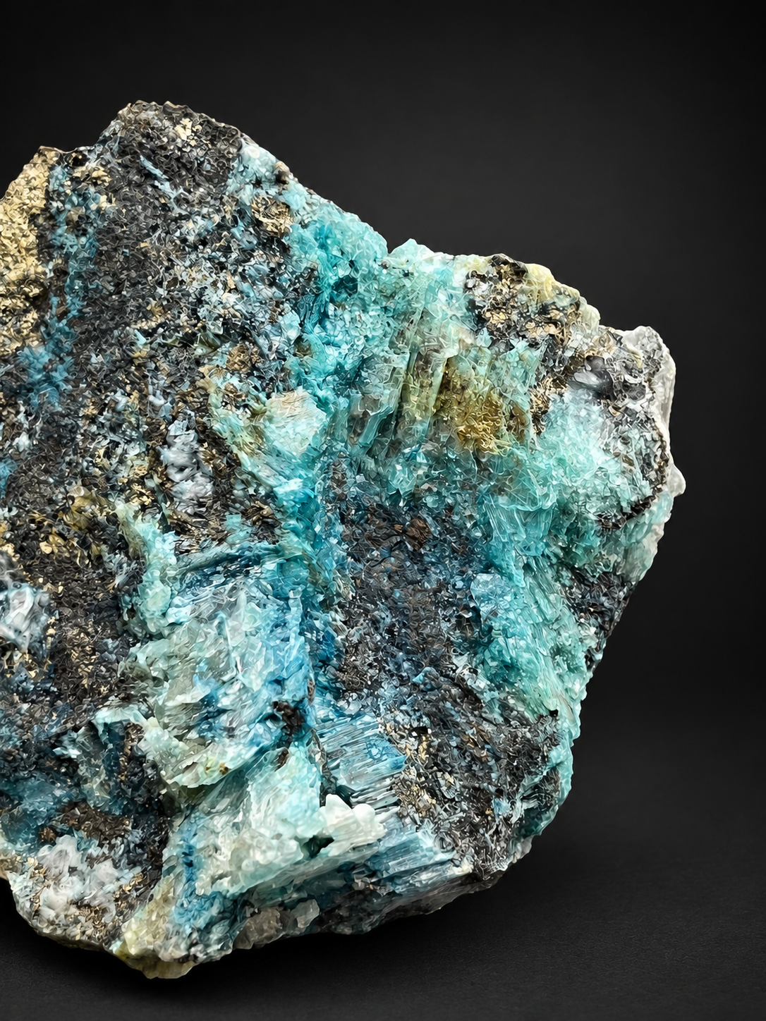 Mexican blue selenite specimen showing layered turquoise mineralization, cream-colored selenite crystals, and dark metallic areas.