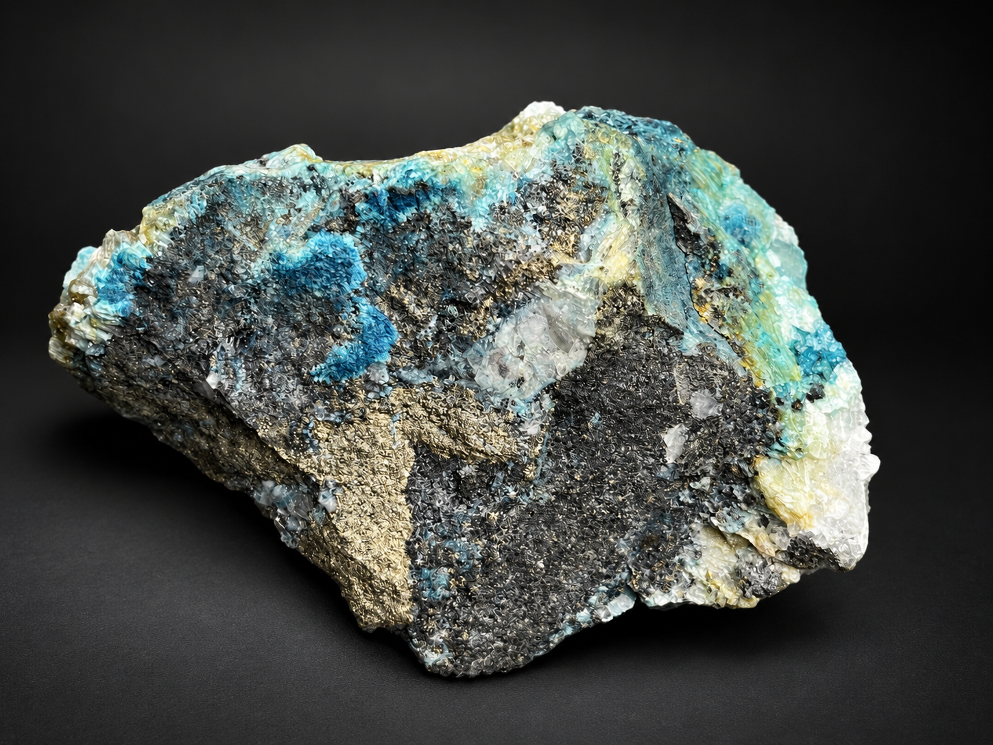 Macro photograph of turquoise-blue mineralization, translucent selenite crystal formations, and dark textured areas on a Mexican mineral specimen