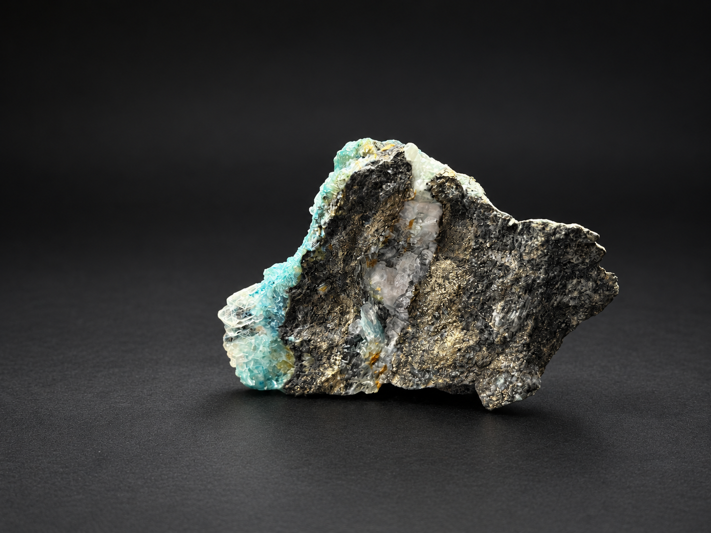 Blue Selenite on Shattuckite from Ojuela Mine, showing dark mineral textures, clear white crystal pockets, and vivid turquoise along one edge.