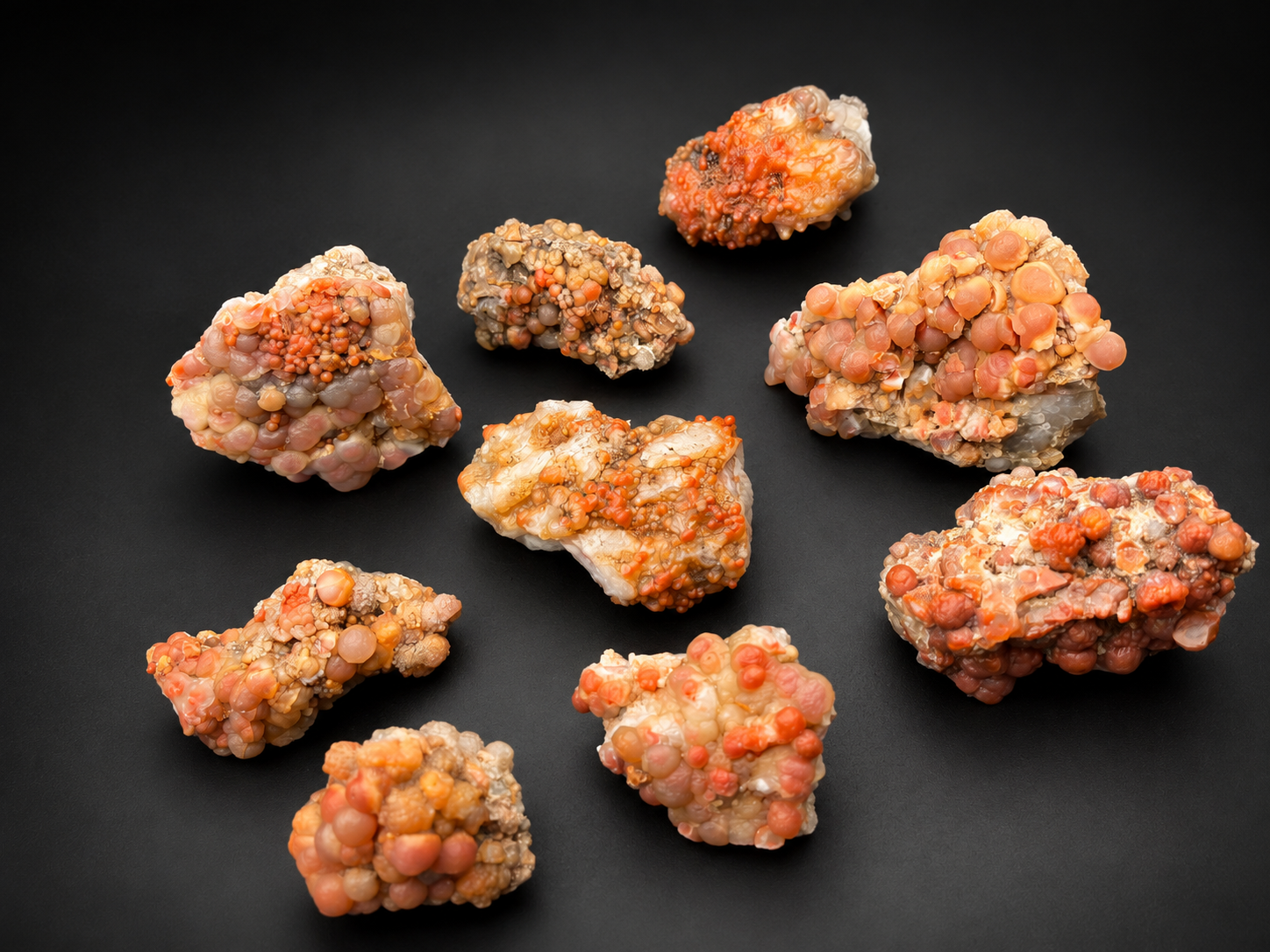Utah Red Grape Agate showing large peach and coral-colored chalcedony spheres with smaller orange botryoidal clusters.