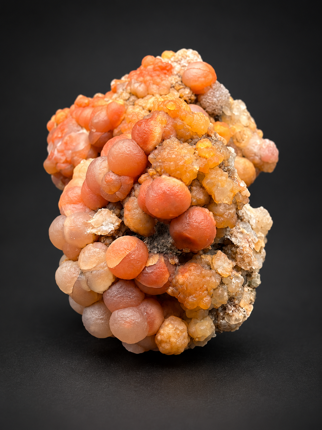 red Grape Agate specimens from Utah featuring grape-like chalcedony formations in red, orange, peach, and cream