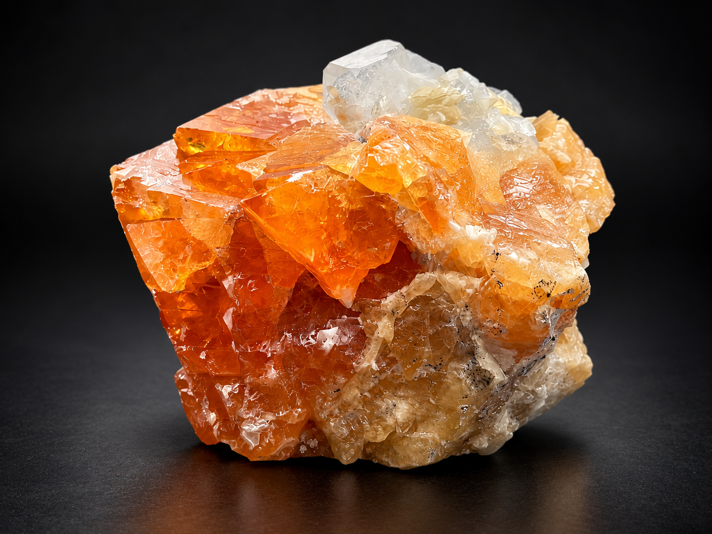 translucent orange scheelite showing intergrown geometric crystals, golden internal color, and contrasting clear calcite from Mt. Xuebaoding, China.
