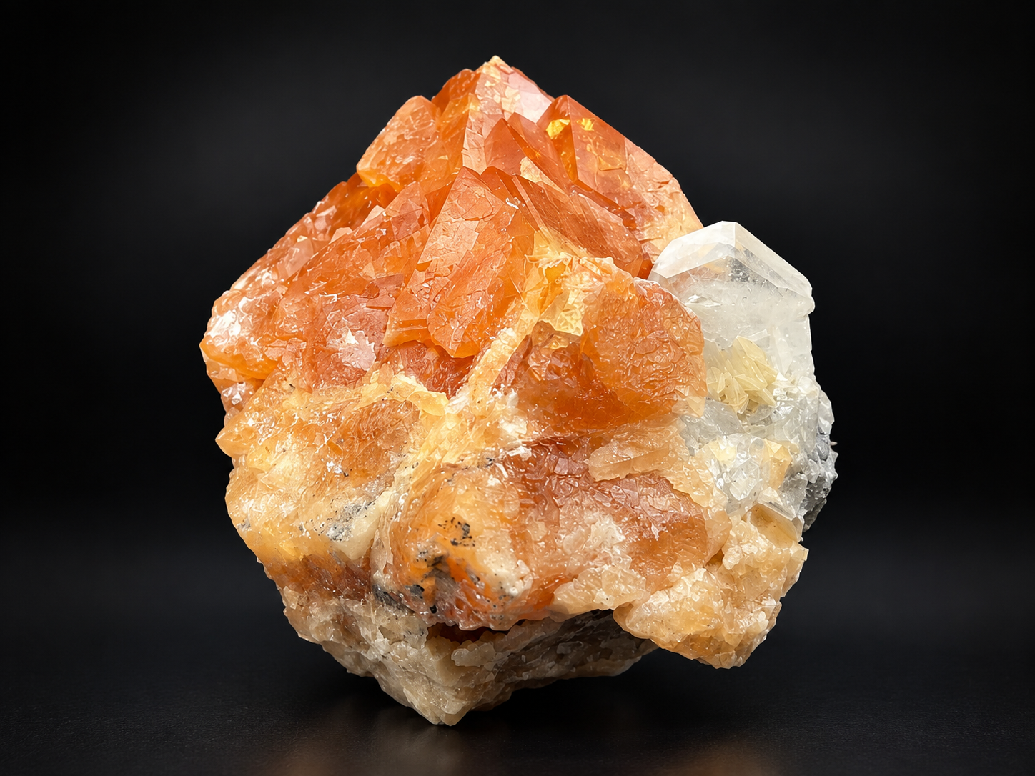 orange scheelite crystals with clear calcite and pale muscovite from Mt. Xuebaoding, China, featuring sharp geometric formations and amber translucency