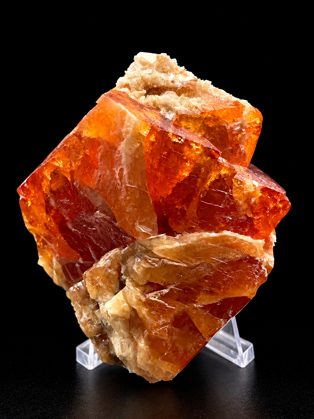 fiery orange scheelite showing broad crystal faces, glassy luster, and a contrasting cream-colored muscovite association from Sichuan, China.