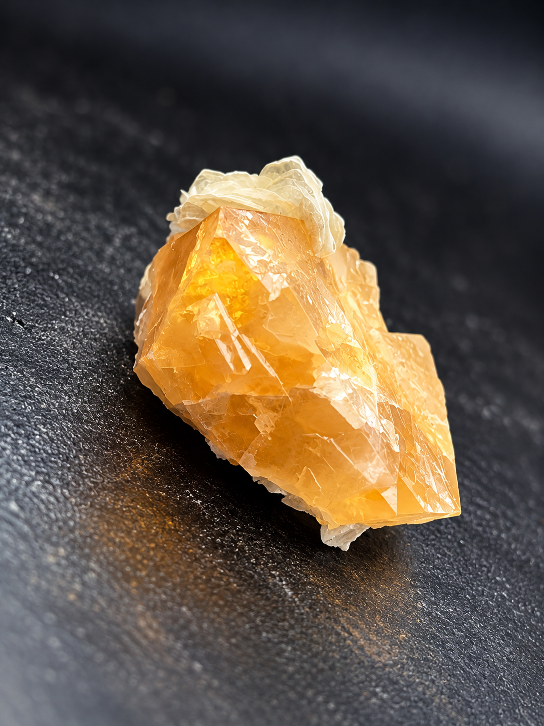 Golden-orange scheelite crystals with a cream-colored muscovite rosette from Mt. Xuebaoding, China, showing translucent faces and intergrown crystal formations.