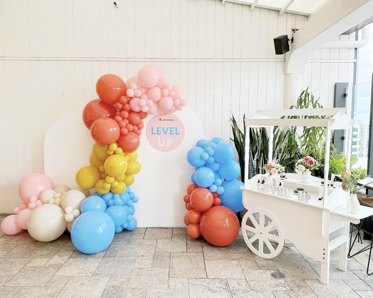 Arbonne Level Up balloon installation, Willow arch backdrops, candy cart and personalised sign hire.jpeg
