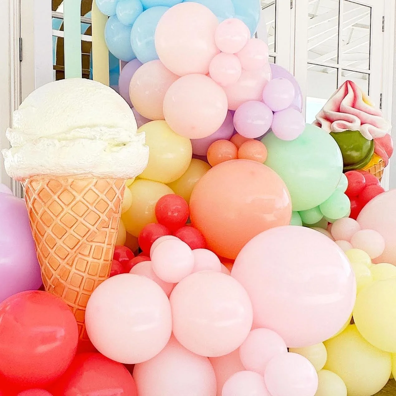 Vanilla Ice Cream Prop with balloons and Coco Rainbow Backdrop.jpeg