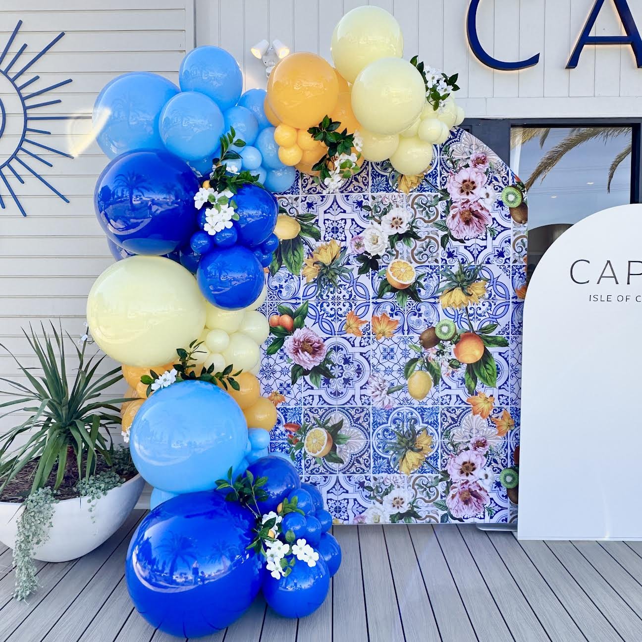 Positano backdrop with flowers & balloon garland by Print Candy.jpeg