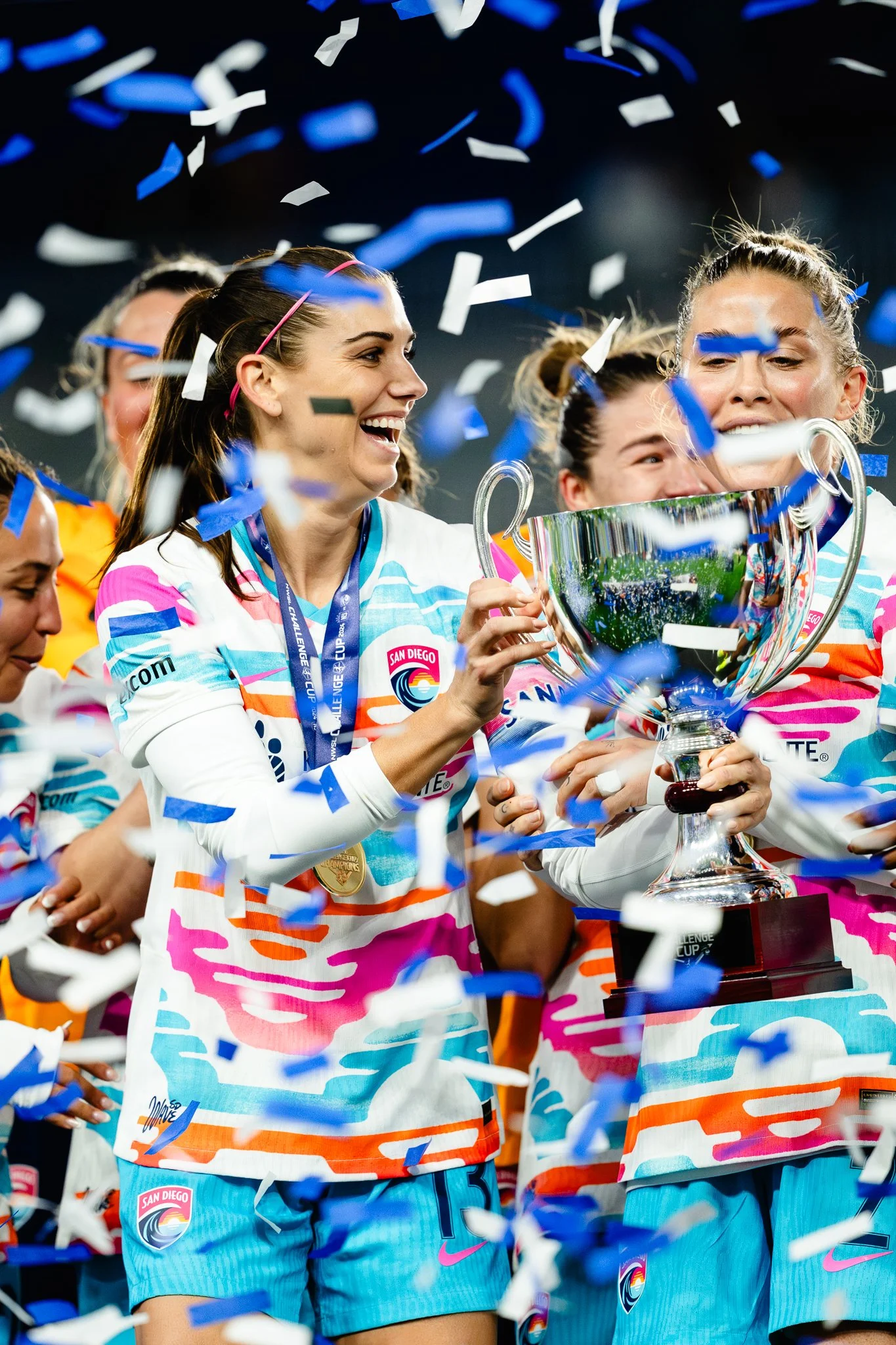 Alex Morgan of San Diego Wave holds trophy after winning Challenge Cup.