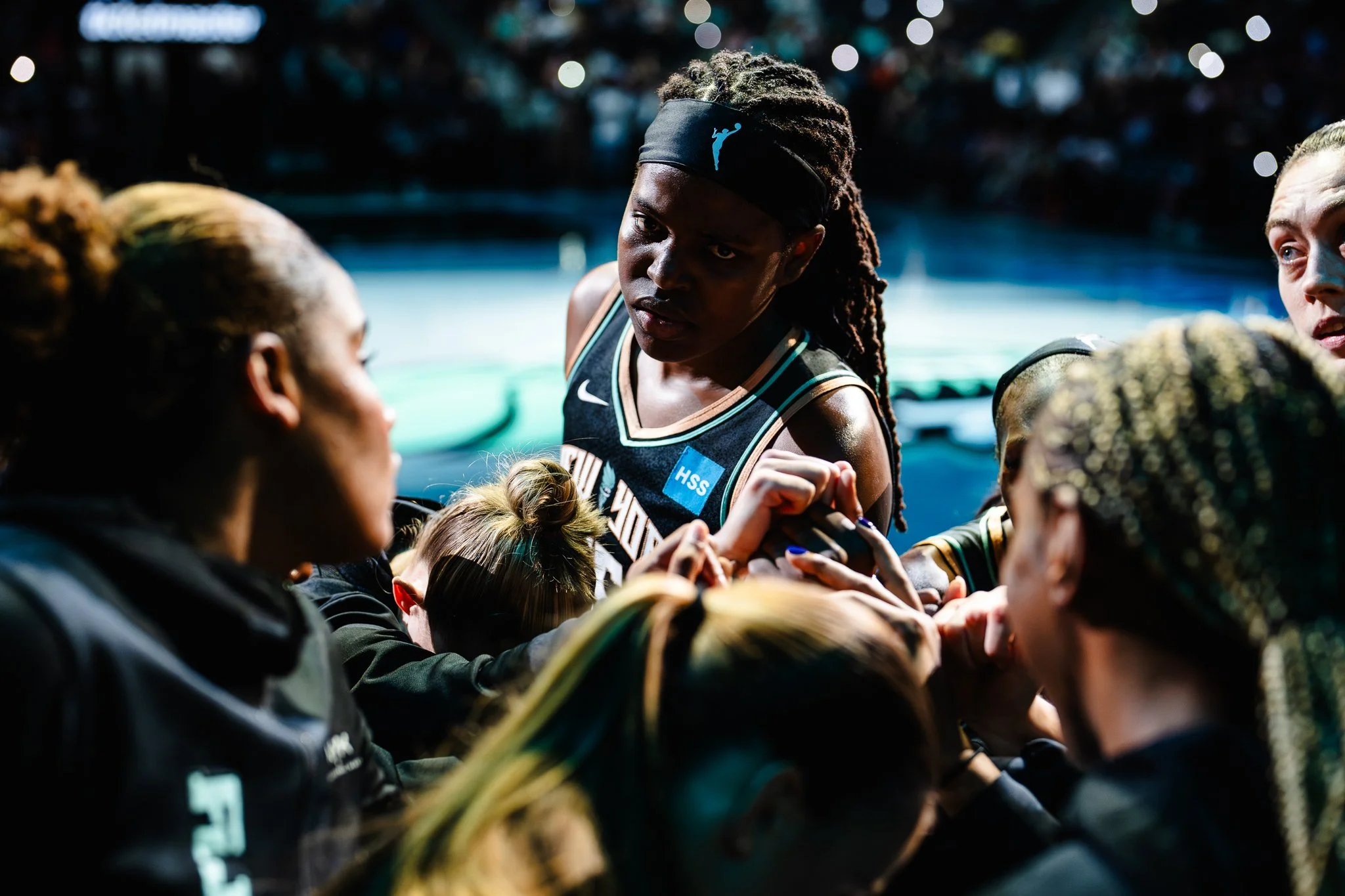 Jonquel Jones of New York Liberty huddles with team.