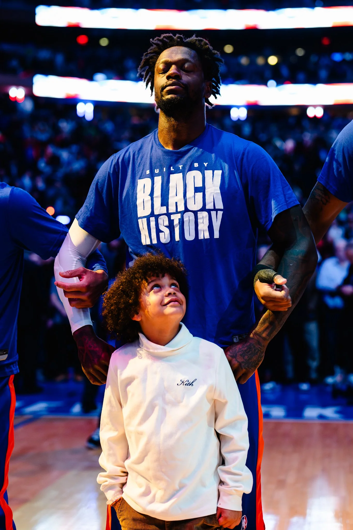Julius Randle of New York stands with son for National Anthem.