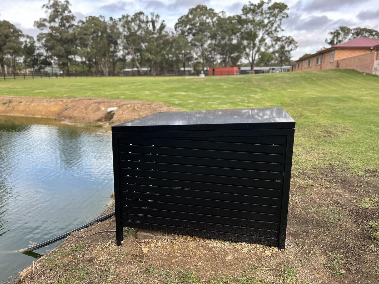 A recently installed custom fabricated dam pump cover powdercoated in Satin black. This was all fabricated in house using 50x50x3mm alloy for the uprights and supports and 65x16mm RHS for the horizontal slats. The roof is installed on gas struts to a
