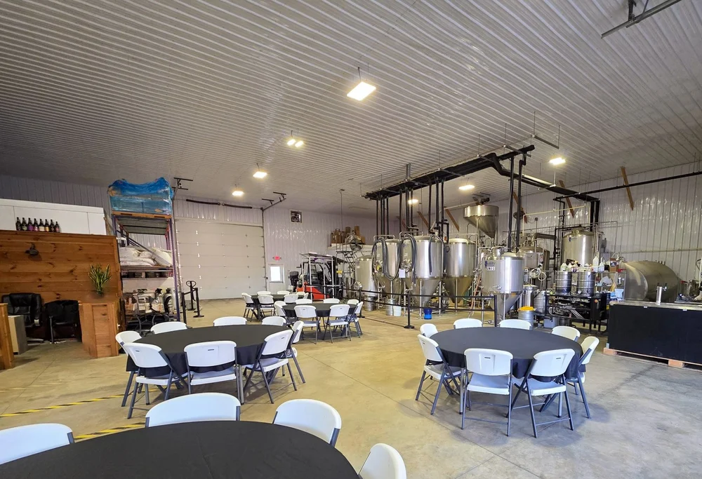 The brewhouse set with round tables for a private event