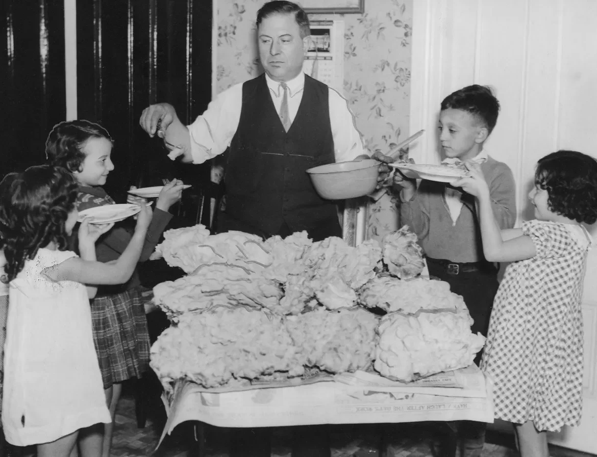 1935: Because this mushroom is so large, Mike Morso, of Providence, is distributing some of it to a few youngsters in the neighborhood. In case you're curious, all that amorphous stuff on the table is a single mushroom from the woods in Lakewood. A "