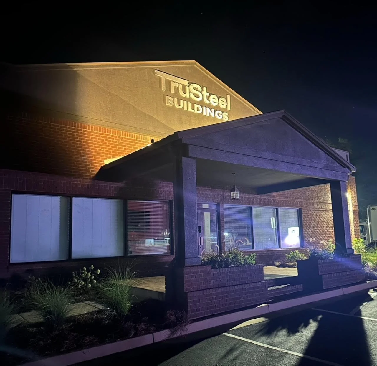 Commercial outdoor architectural lighting on an Athens Georgia retail storefront and hospitality patio at twilight