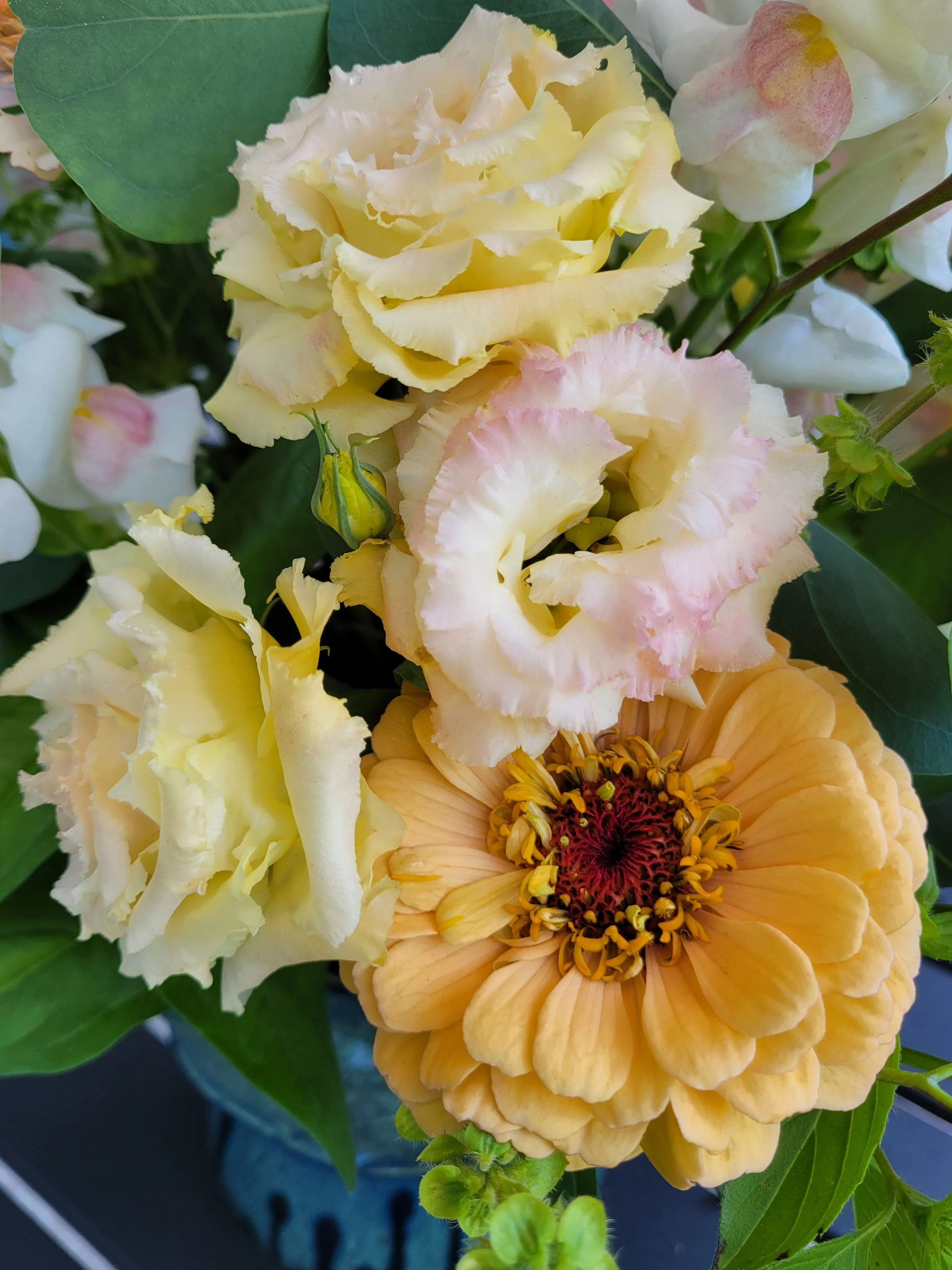 Peachy orange zinnia with variety of lisianthus