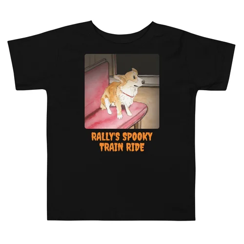 Rally's Spooky Train Ride Halloween toddler tee in black, printed with Rally the corgi on a red train seat in the dark tunnel