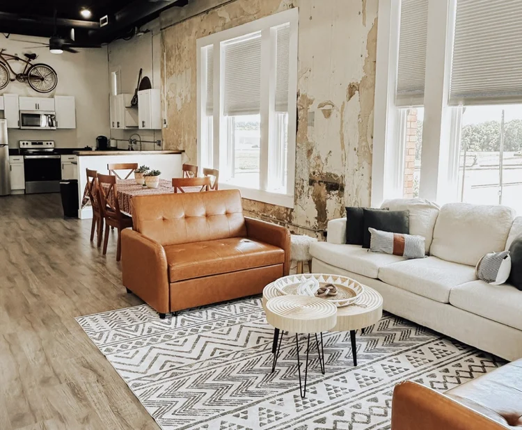 A Katy Depot loft with original plaster walls, tall windows and a modern kitchen
