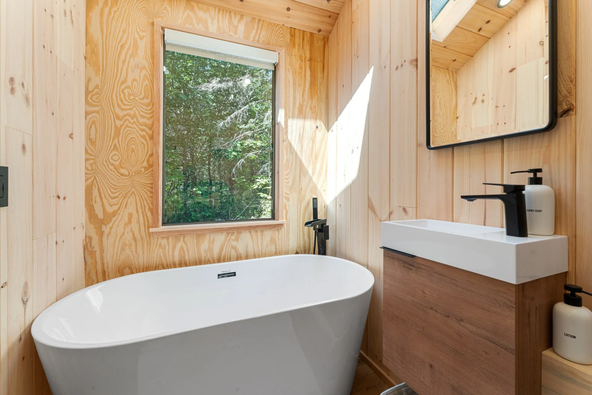Pine walls in modern bathroom with soak tub