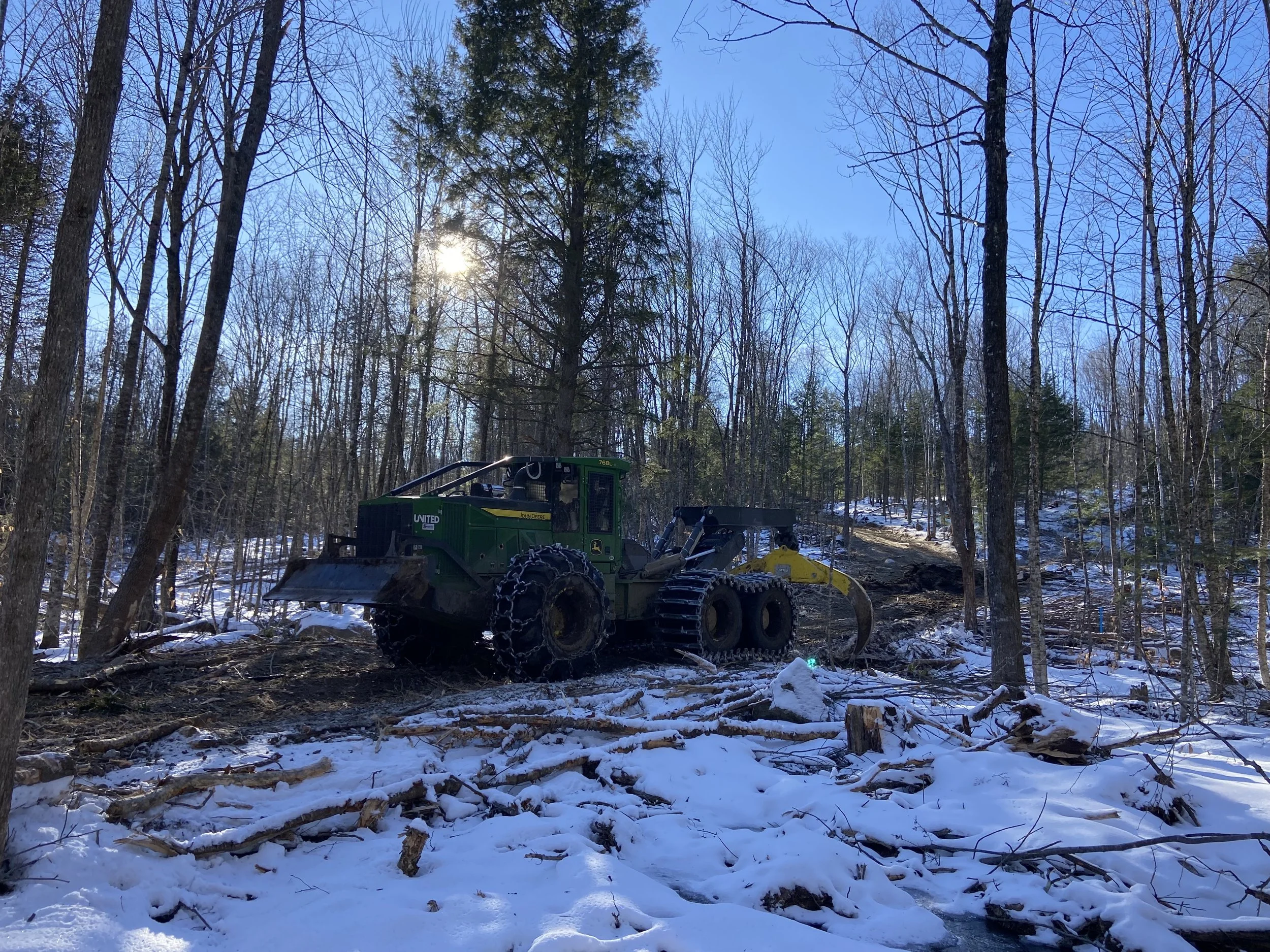 Six Wheeled Grapple Skidder - drags bunches of trees from the woods to the landing.