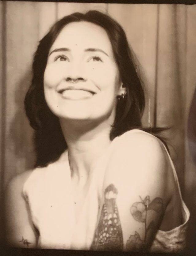 mallory smiles in a black and white photobooth photo strip