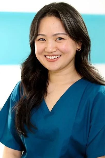 Rachna Rai, a dental therapist in blue uniform