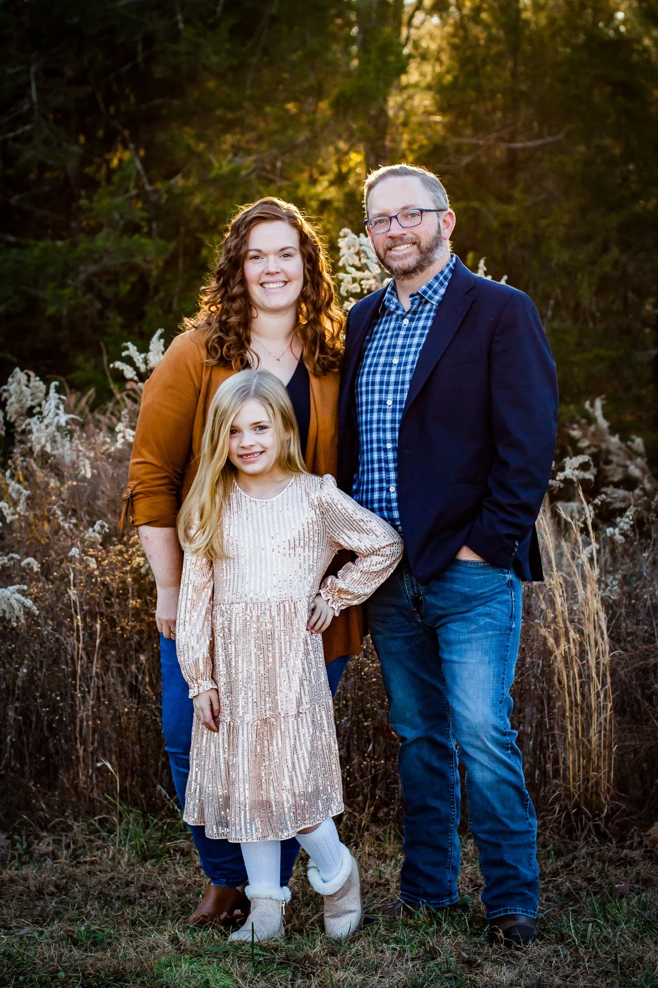Daniel Troupe, filmmaker behind Lynn Films, standing outdoors with his wife and daughter.