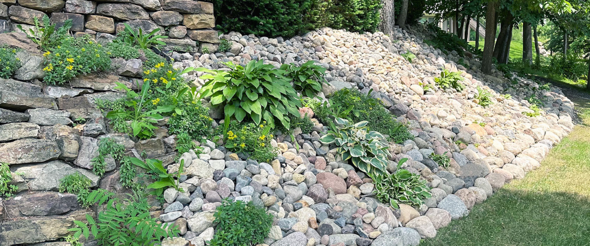 Our Plymouth client was frustrated by their hillside eroding with every rainfall. Traditional solutions had failed to provide lasting relief. We devised a custom solution to stabilize the slope and enhance its aesthetic appeal. By strategically insta