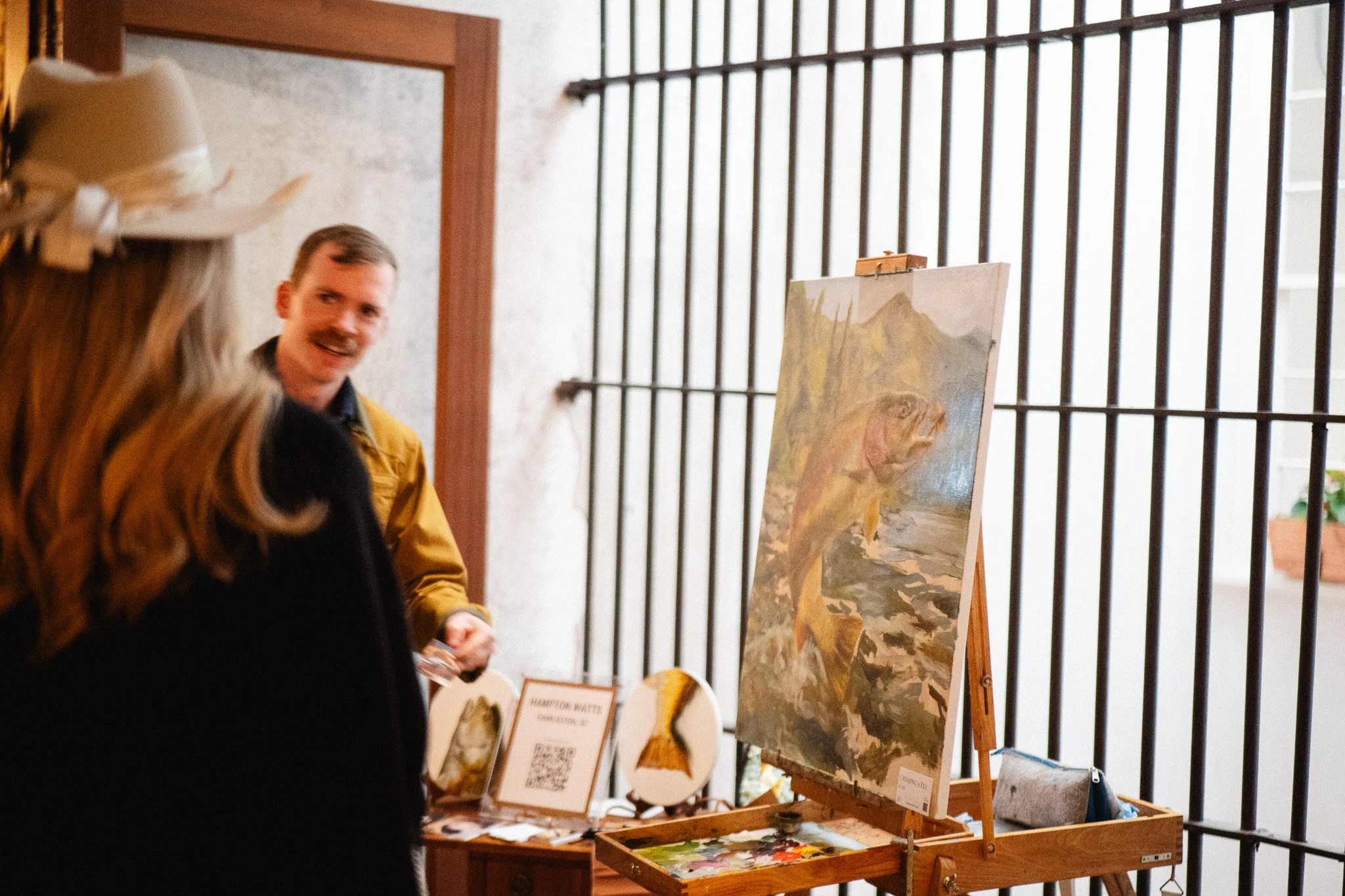 Oil painting of a rainbow trout titled Chasing a Fly by Hampton Watts — live painting at SEWE with Garden and Gun Charleston