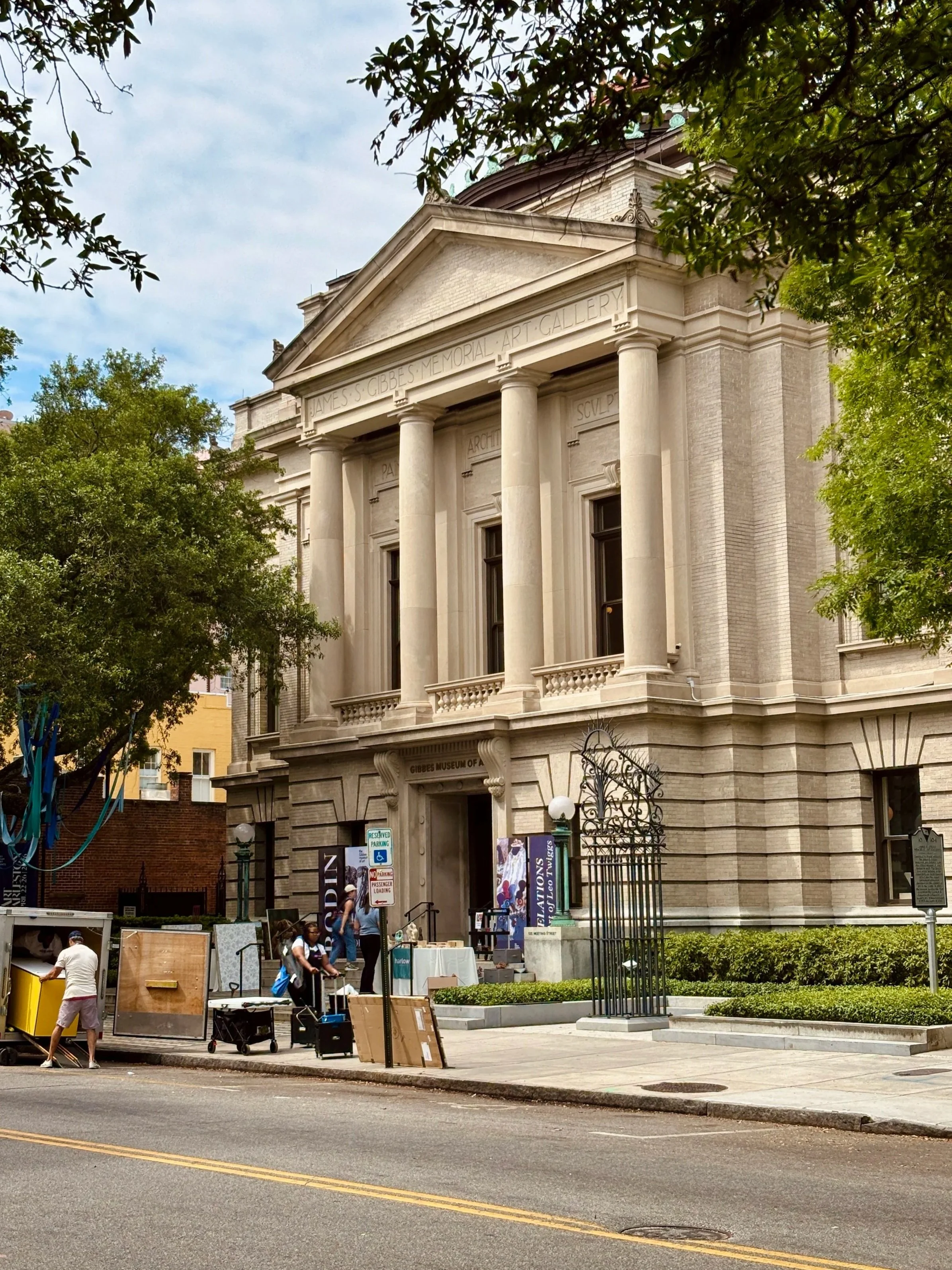 The Gibbes Museum of Art on Meeting Street in Charleston, South Carolina, during Art Charleston setup, with the James S. Gibbes Memorial Art Gallery facade and live art event preparations visible