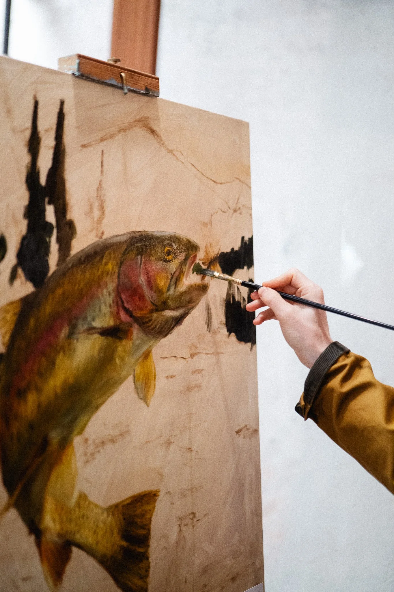 Oil painting of a rainbow trout titled Chasing a Fly by Hampton Watts — live painting at SEWE with Garden and Gun Charleston