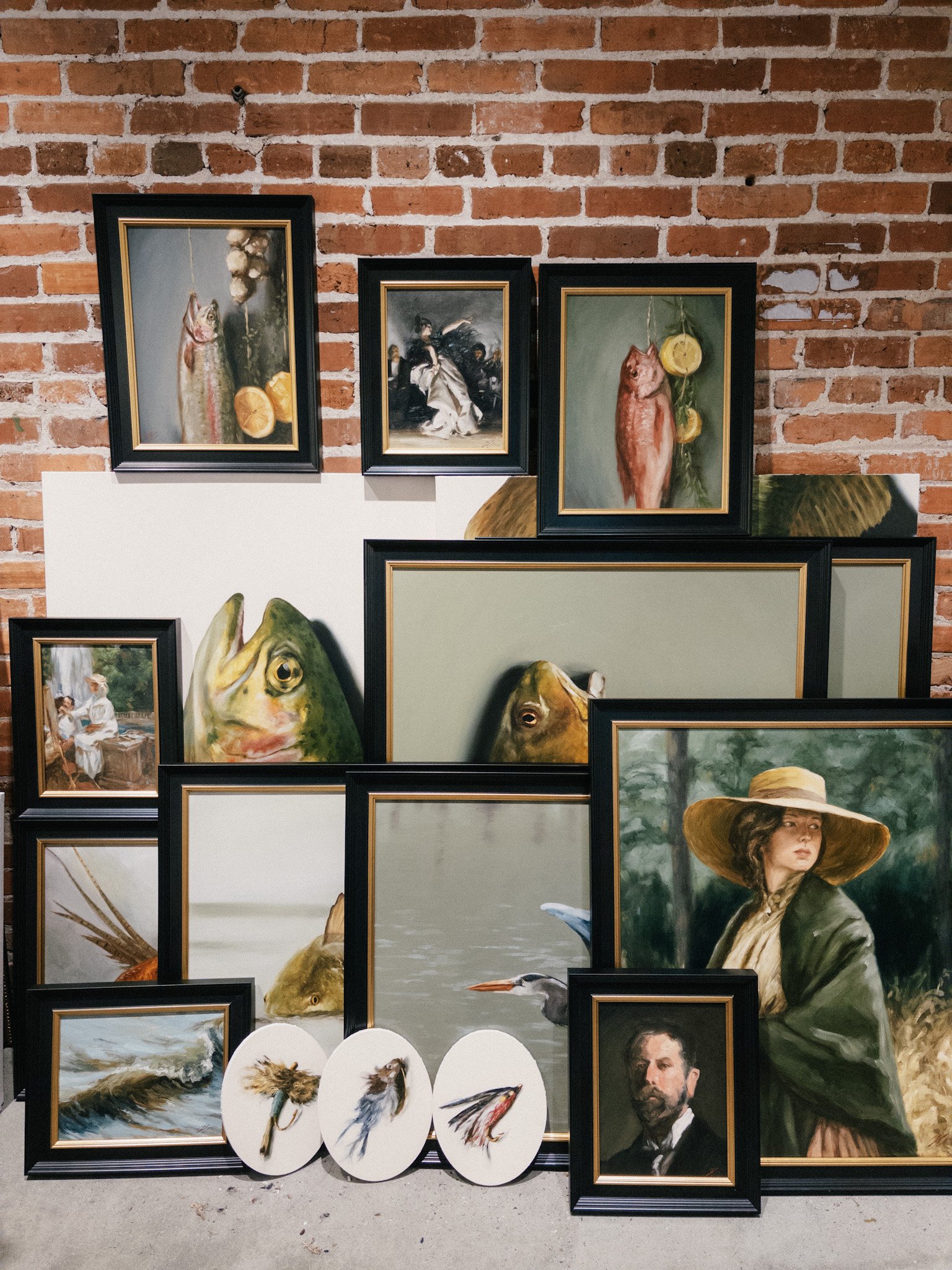 A collection of framed oil paintings by Hampton Watts including trout and redfish still lifes, fly lure tondos, a great blue heron, and classical portraits