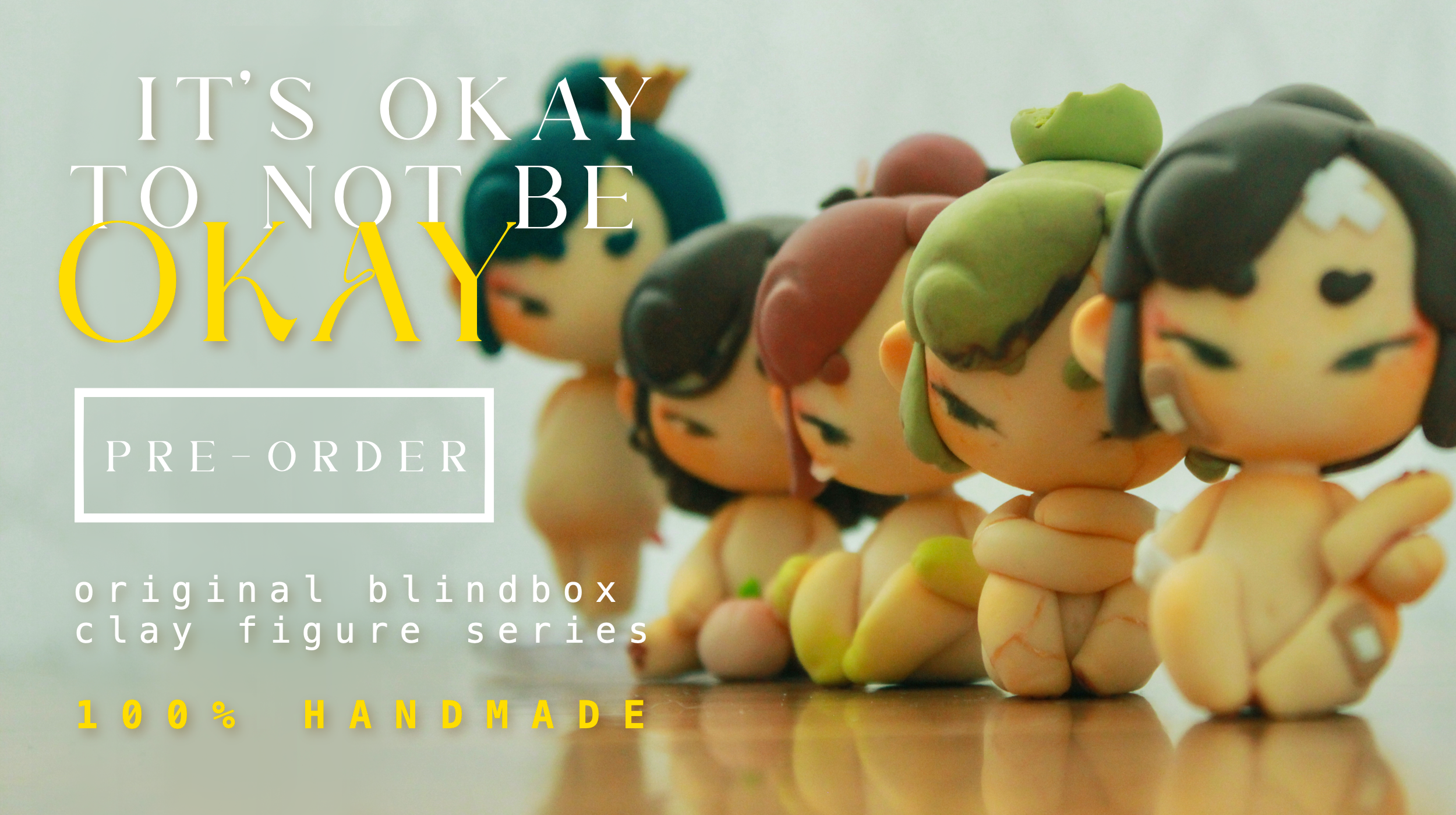 Colorful figurines from the original blind box series arranged on a wooden surface with overlaid text reading 'It's okay to not be okay' and a button labeled 'Buy now'.