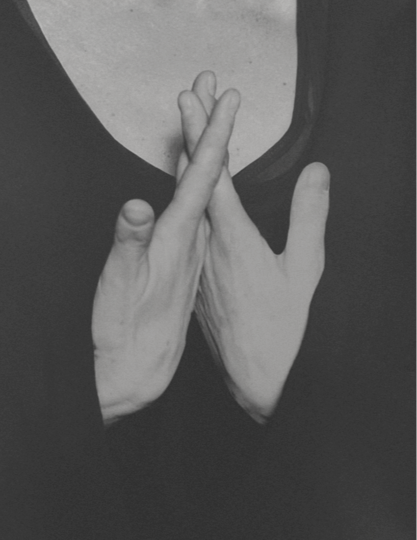 Close-up of a person's hands in a prayer/mudra position, expressive of pure alignment.