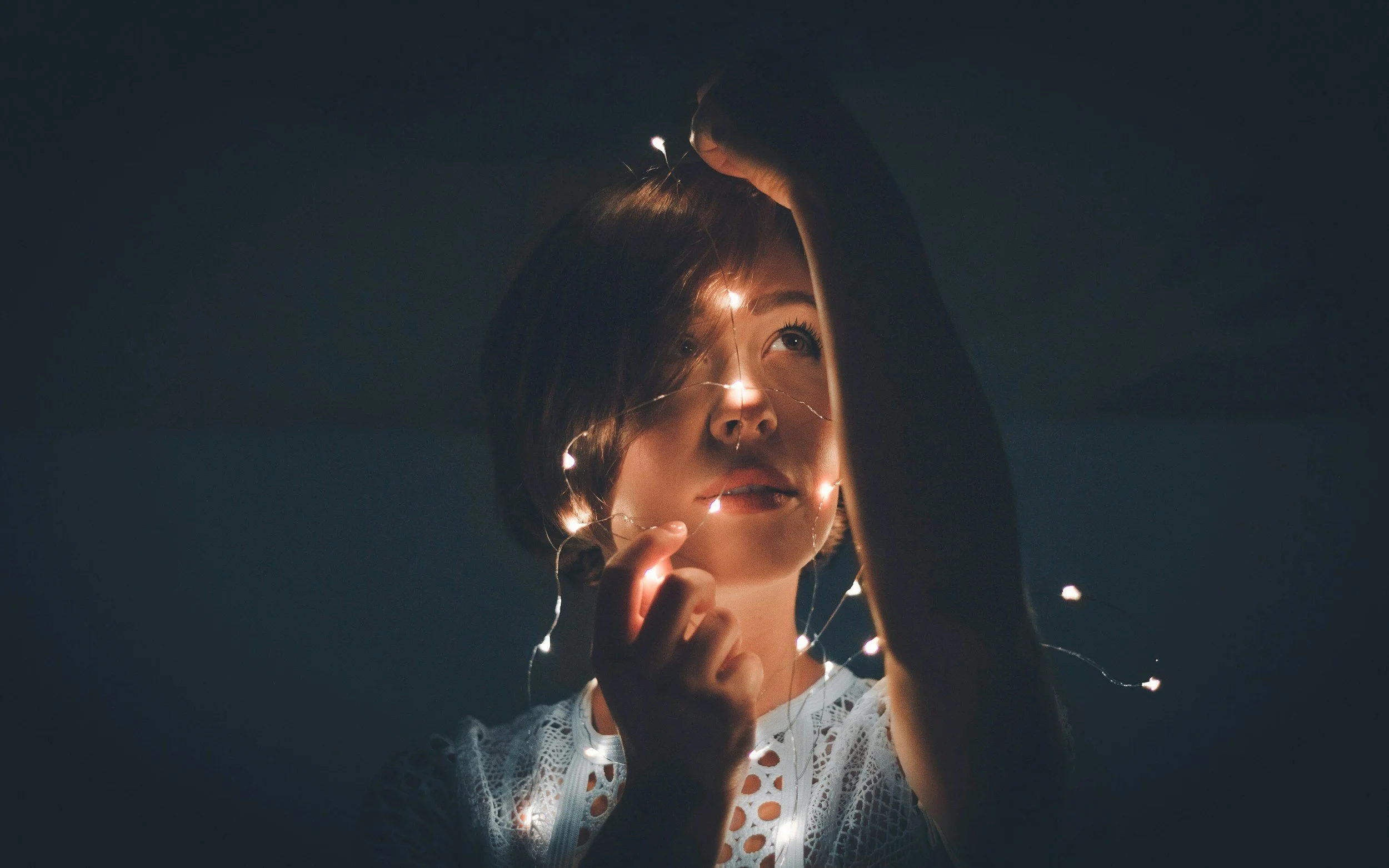 Woman standing in light, symbolising reconnecting with yourself, gaining clarity and embracing meaningful change.