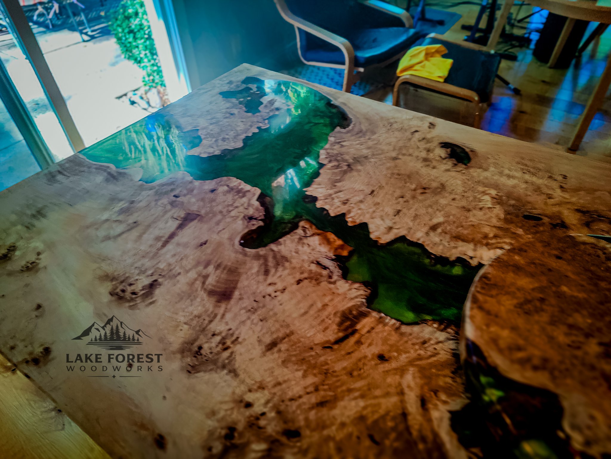 Full table in dining room setting, with natural light highlighting the epoxy’s shine and wood’s figure.